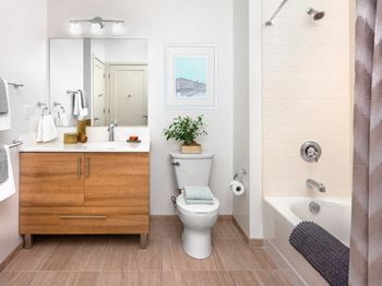 a bathroom with a toilet and a sink and a shower